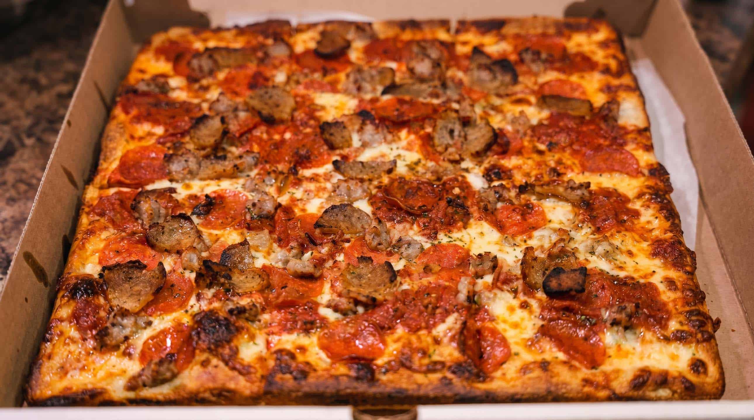 Sicilian-style pizza with pepperoni and sausage